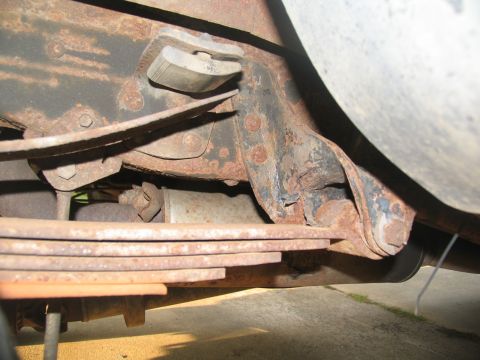 1995 Ford C-350 (Centurion Conversions) - The vehicle's undercarriage shows significant rust on the leaf spring and frame components.