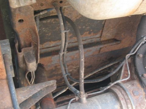 1995 Ford C-350 (Centurion Conversions) - The underside of the vehicle shows significant rust on the frame and brake lines.
