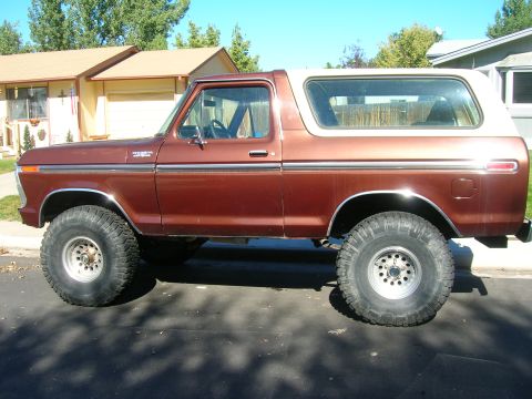 1979 Ford Bronco - Side profile of a lifted 1978 Ford Bronco with off-road tires and a white top.