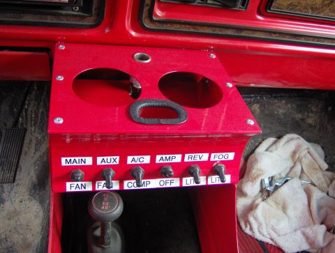 1978 Ford Bronco - Custom dashboard console features multiple switches for various functions, including fan, A/C, and lighting.
