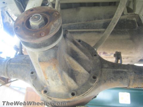 1987 Suzuki Samurai - Underside view of a vehicle's rear axle assembly, showing the differential housing and driveshaft connection.