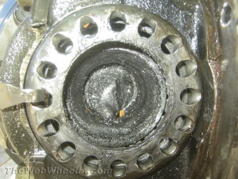 1987 Suzuki Samurai - Close-up view of a severely damaged axle hub, indicating a broken axle shaft.