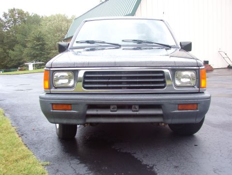 1993 Mitsubishi FTO - Frontal view of a dark gray pickup truck, a chrome grille and amber turn signals.