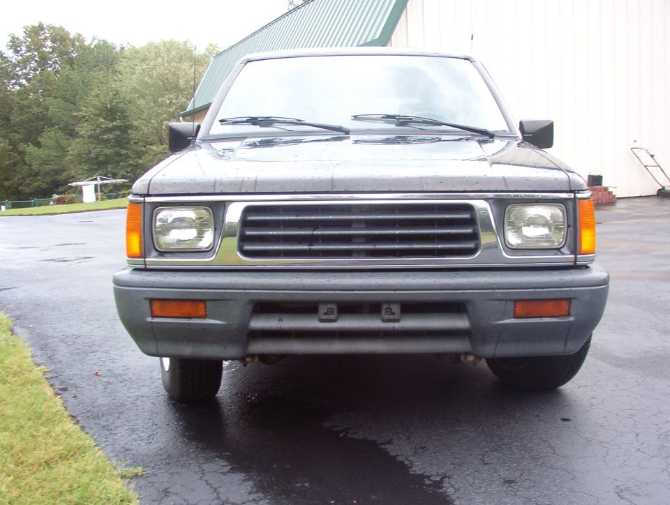 Front of dark gray pickup truck with chrome grille
