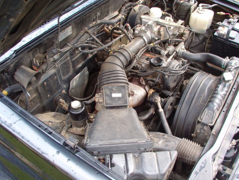 1993 Mitsubishi FTO - Engine bay of a vehicle, showing various components and wiring.