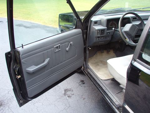 1993 Mitsubishi FTO - View of the interior of a black pickup truck, highlighting the gray door panel and dashboard area.