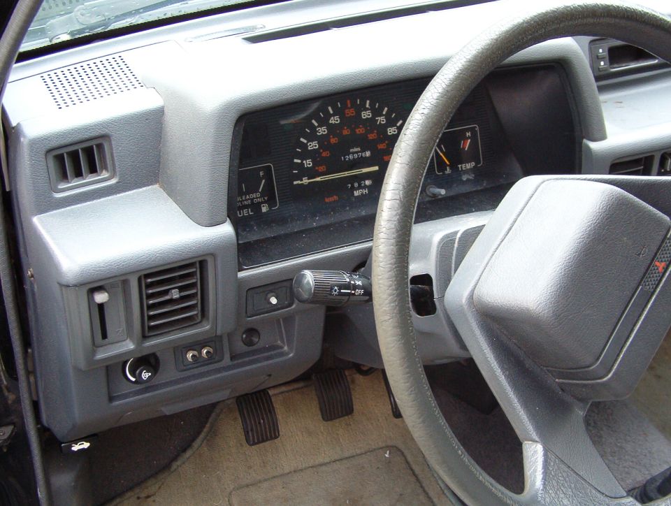 Interior dashboard with odometer showing 136974 miles and 78780 km