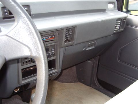 1993 Mitsubishi FTO - The interior of a car shows the dashboard, steering wheel, and center console with radio and climate controls.