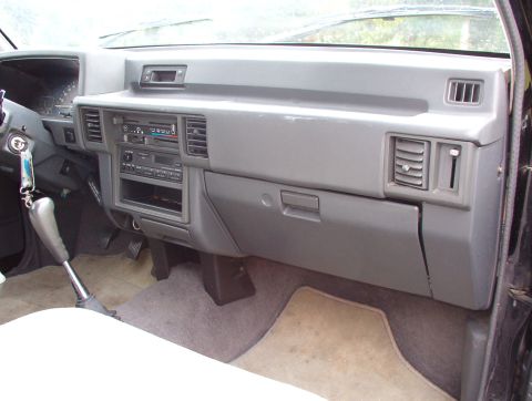 1993 Mitsubishi FTO - The interior dashboard shows a radio, air vents, and a gear shifter.