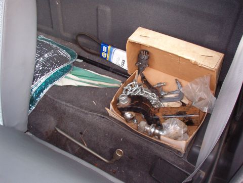 1993 Mitsubishi FTO - Tools and spare tire stored in the cargo area of a vehicle.