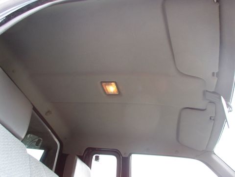 1993 Mitsubishi FTO - The interior ceiling of a vehicle is visible, showing a light and sun visors.