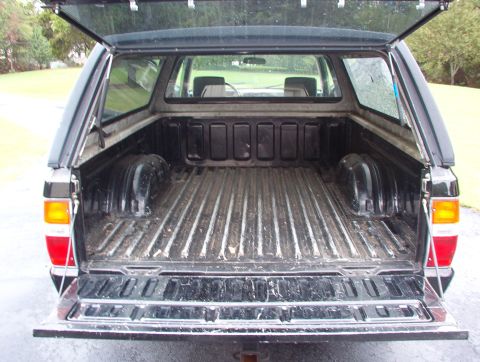 1993 Mitsubishi FTO - Pickup truck bed with camper shell, showing the interior of the bed.