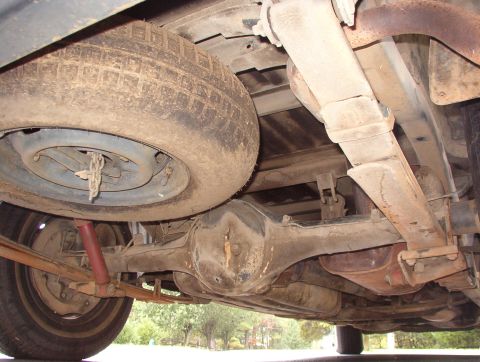 1993 Mitsubishi FTO - The underside of a vehicle is shown, including the spare tire and suspension components.