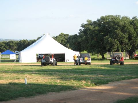 2001 Jeep Wrangler - Several Jeep Wranglers are gathered near a large tent at an outdoor event.