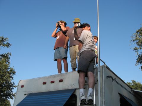 2001 Jeep Wrangler - People are standing on top of an RV, with some taking pictures of the sky.