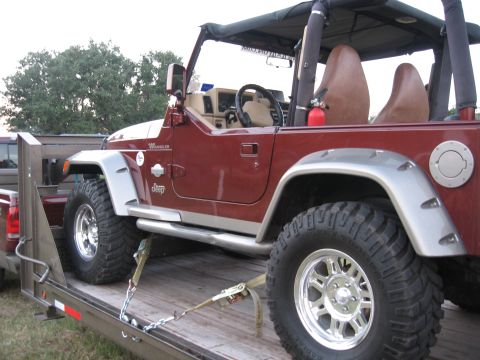 2001 Jeep Wrangler - Maroon 2001 Jeep Wrangler secured to a trailer with straps and chains.