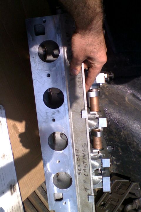 1964 Ford 427 - Close-up of an engine cylinder head, likely aftermarket, with visible casting marks and internal components.