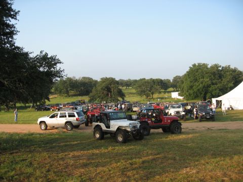 2001 Jeep Wrangler - A large gathering of Jeep Wranglers and other SUVs parked in an outdoor setting.