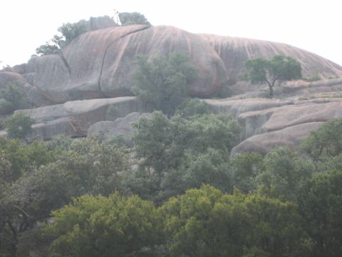 2001 Jeep Wrangler - A large rock formation dominates the landscape, with trees growing on and around it.