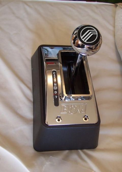 1988 Mercury Grand Marquis - A close-up of a chrome automatic transmission shifter with a Mercury logo on the knob and B&M branding.