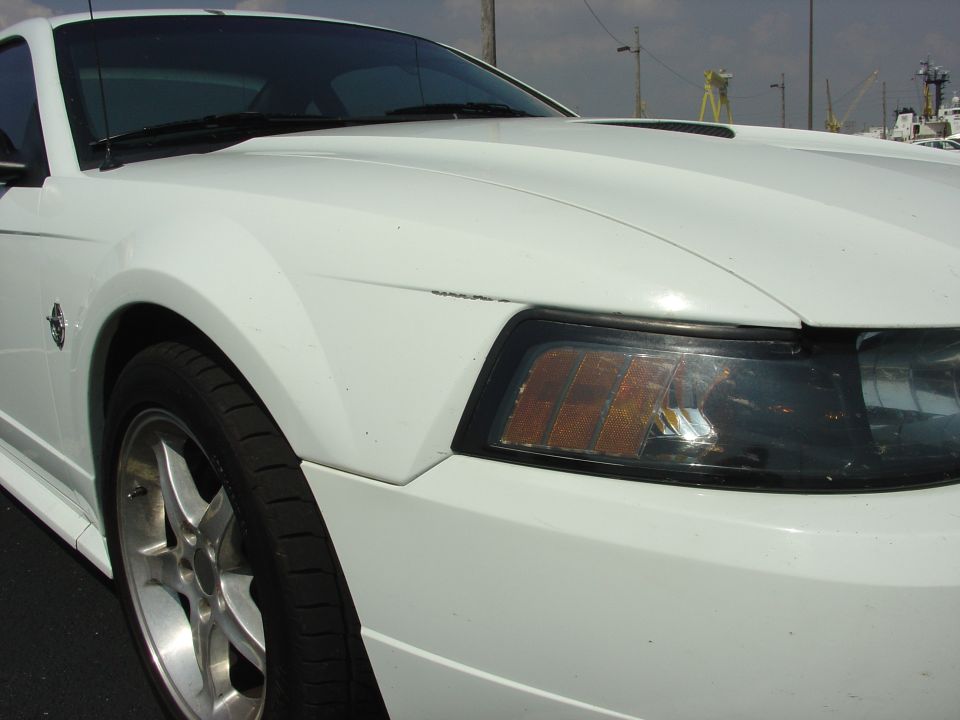 White 1999 Ford Mustang front fender and headlight