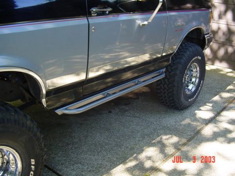 1991 Ford Bronco - This 1991 Ford Bronco features custom rock sliders and off-road tires, as seen in this side profile shot.