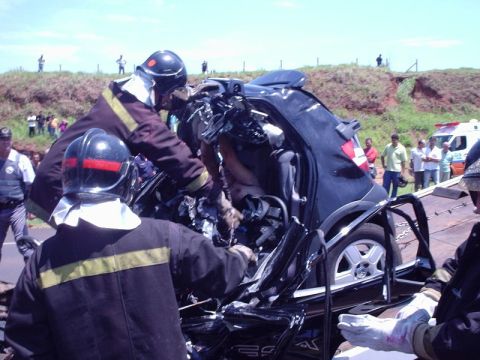 1987 Ford Thunderbird - Emergency responders attend to a severely damaged vehicle at the scene of a car accident.