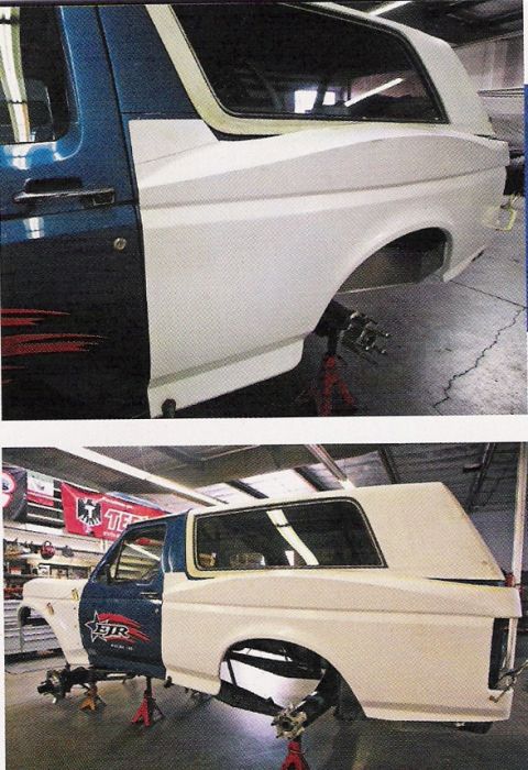 1984 Ford Bronco - This Ford Bronco is undergoing modifications in a workshop, with its rear section being repainted white.