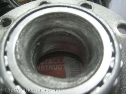 1987 Suzuki Samurai - A close-up view of a wheel bearing assembly, with text from installation instructions visible within the housing.