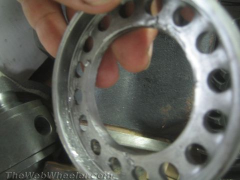 1987 Suzuki Samurai - Close-up of a metal ring with multiple holes, possibly a bearing or gear component.