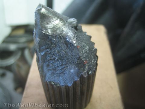 1987 Suzuki Samurai - Close-up of a fractured metal axle shaft, showing the break point and ribbed end.