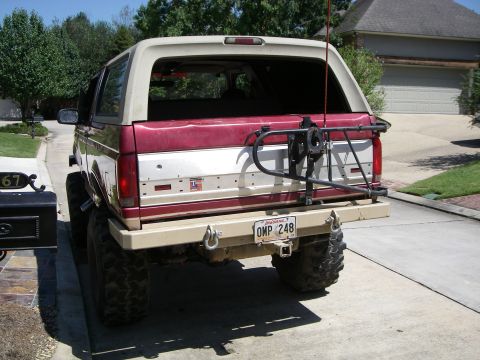 1995 Ford Bronco - This Ford Bronco features a two-tone paint scheme and oversized tires, suggesting it's from the early to mid-1990s.