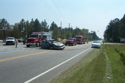 1998 Ford Crown Victoria - Emergency services respond to a multi-vehicle accident on a two-lane road, with one car heavily damaged.