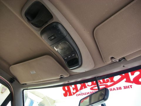 1995 Ford Bronco - The interior overhead console and sun visors are visible in this vehicle's cabin.