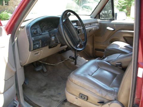 1995 Ford Bronco - Interior view of a 1995 Ford Bronco, tan leather seats and dashboard.