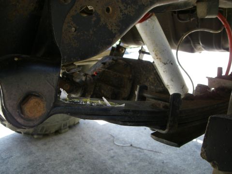 1995 Ford Bronco - Close-up view of the suspension system components on a vehicle's undercarriage.