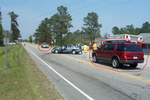 1998 Ford Crown Victoria - A car accident occurred on a road, involving a sedan, an SUV, and an ambulance, with emergency personnel on site.