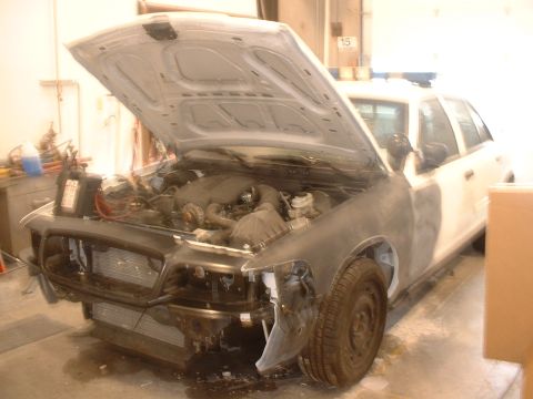 2000 Ford Crown Victoria - This 2000 Ford Crown Victoria is undergoing repairs with its hood and front end removed.
