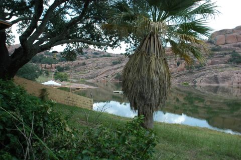 2001 Jeep Wrangler - A landscape a calm lake reflecting the sky, surrounded by rolling hills and lush vegetation.