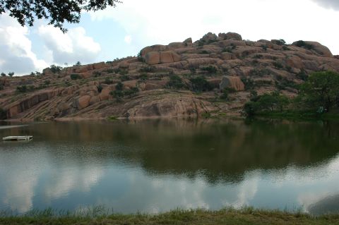 2001 Jeep Wrangler - A scenic view of a rocky landscape and a tranquil lake on a partly cloudy day.