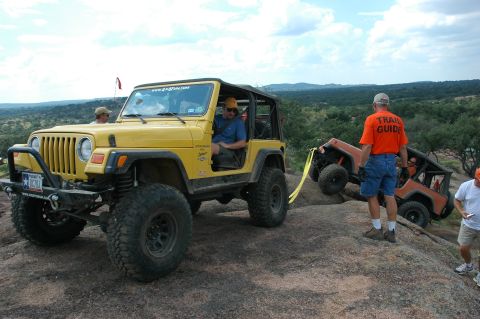 2001 Jeep Wrangler - Two Jeep Wranglers navigating a rocky trail, with one assisting the other.