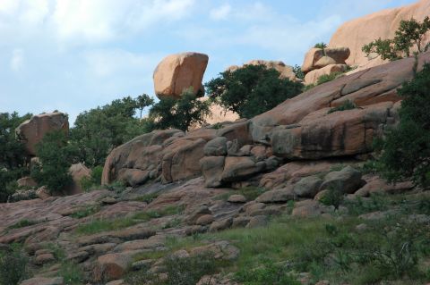 2001 Jeep Wrangler - A natural scene of large granite boulders and sparse vegetation under a partly cloudy sky.