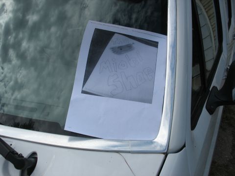 1978 Ford Bronco - A drawing of a shoe is taped to the inside of a vehicle's windshield.