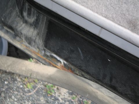 1991 Ford LTD Crown Victoria - Rust forming on the lower edge of a car door sill.