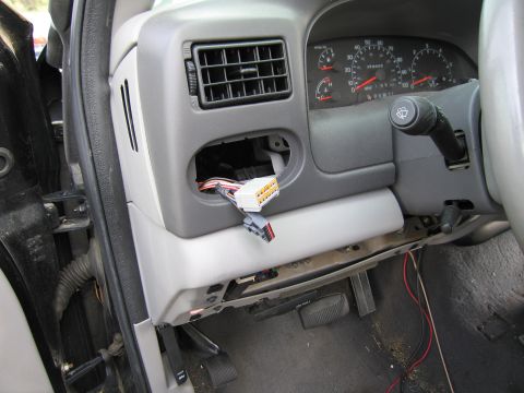 1991 Ford LTD Crown Victoria - Exposed wiring and dashboard components are visible inside a truck's interior.