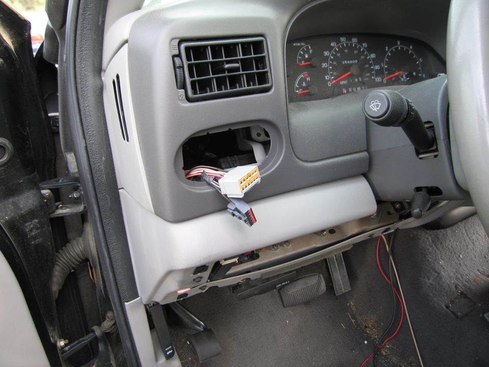 Interior view of a truck dashboard with exposed wiring and gauges