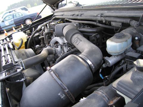 1991 Ford LTD Crown Victoria - Close-up view of a vehicle's engine bay, showing various components.