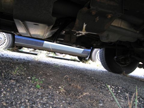 1991 Ford LTD Crown Victoria - Underside view of a car, revealing its frame, exhaust system, and tires.