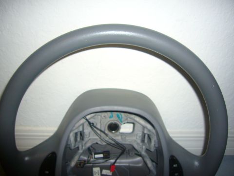 2000 Ford Crown Victoria - This is a gray steering wheel, likely from a Ford Crown Victoria, with visible wiring and mounting components.