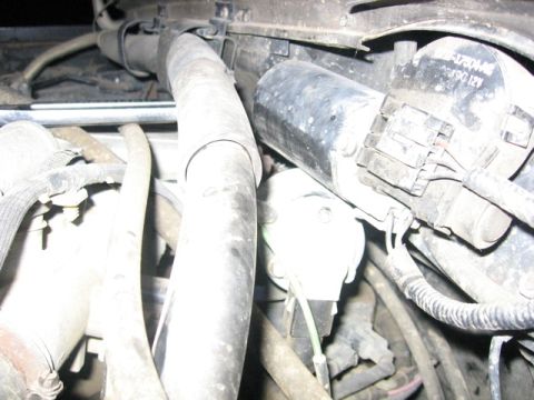 1989 Ford Bronco - Close-up view of engine components, including hoses and electrical wiring, with visible part number information.